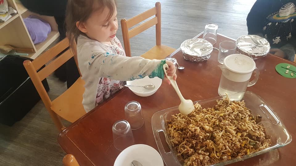 child care nutrition - Children watch food preparation at Apple Blossoms Early Learning